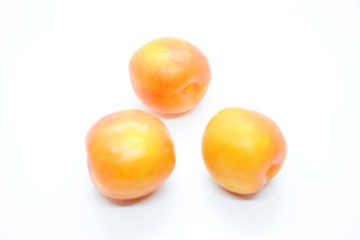 Inculate ripe plums located on a white background