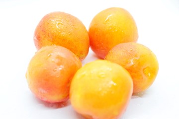 Inculate ripe plums located on a white background