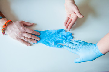 Doctor wears medical gloves. Blue latex medical gloves on a woman's hand, o