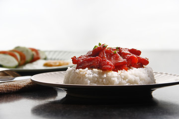 Freshly cooked Tocino or cured pork meat served with fried rice and egg with vegetables