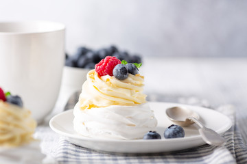 Delicious Pavlova cake with whipped cream and fresh berries. Close-up. Selective focus