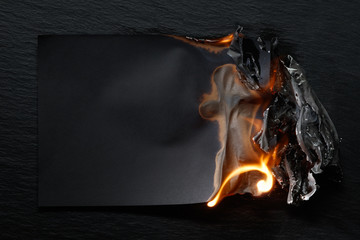 Empty burning paper on black background