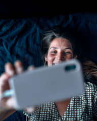 A smiling good looking girl makes a video call during Coronavirus crisis that force everyone to...