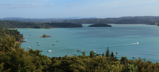 Panorama of Kororareka Bay in the Bay of Islands, New Zealand. Ferries can be seen on the water going to and fro from the town of Russell