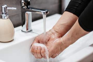 Coronavirus pandemic prevention wash hands with soap warm water and , rubbing nails and fingers...
