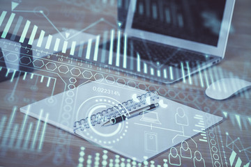 Computer on desktop in office with technology theme hologram. Multi exposure. Tech concept.