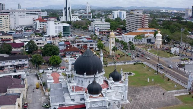 4k Aerial Footage reveal shot of Masjid Zahir Mosque in Alor Setar Kedah revelaling Alor Setar City Skyline