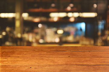 Top of empty of wood table with Blur Interior and decoration of a Modern loftBar and coffee. Using for Mock up template for craft display of your design,Banner for advertise of product.