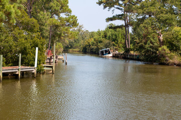 Plash island bon secour river and creeks with trees and half sunken boat