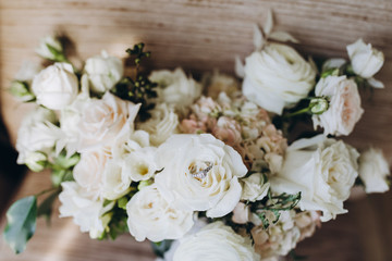 wedding bouquet of white flowers with a ribbon stands in an armchair