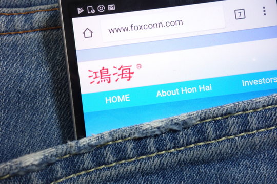 KONSKIE, POLAND - MAY 17, 2018: Foxconn website displayed on smartphone hidden in jeans pocket