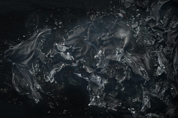 Black and gray ashes with smoke. Texture of burnt paper with smoke and ash. Close-up. Selective focus