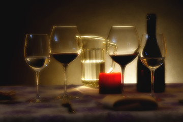 The table set with glasses and a bottle of wine