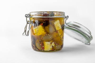 Pickled cheese with herbs, olives. Camembert, brie, mozzarella and dorblu with thyme, sage, rosemary. Gourmet Snack Delicacy. Isolated on White Background