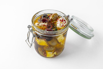 Pickled cheese with herbs, olives. Camembert, brie, mozzarella and dorblu with thyme, sage, rosemary. Gourmet Snack Delicacy. Isolated on White Background