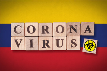 Venezuela flag background and wooden blocks with letters spelling CORONAVIRUS and quarantine symbol on it. Novel Coronavirus (2019-nCoV) concept for an outbreak occurs in Venezuela.