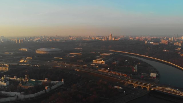 Sdaion Luzhniki on the background of the building of Moscow State University and Moscow River aerial view at dawn.