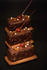 three brown cookies with caramel-dipped hazelnut