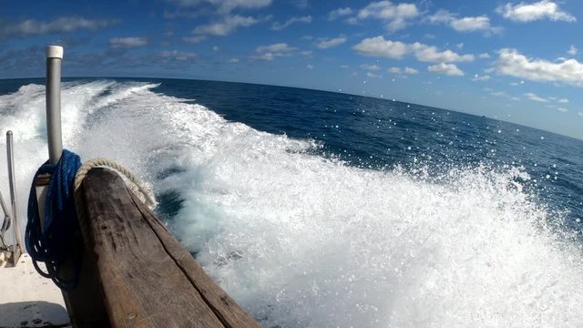 View from side of a dive boat traveling across the sea in Belize