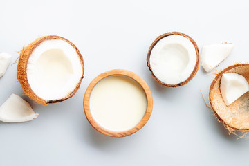 Coconut and bowl of coconut milk on gray background. Healthy food and drink