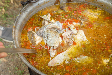 Obraz na płótnie Canvas Traditional fish soup (Carp soup) localy made by villagers in the Danube Delta, Romania