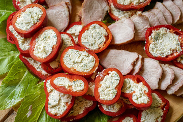Homemade Romanian food platter with peppers stuffed with chees and ham