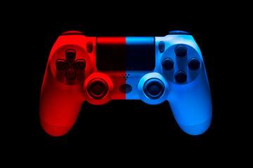 White video game joystick gamepad in blue and red neon lights isolated on black