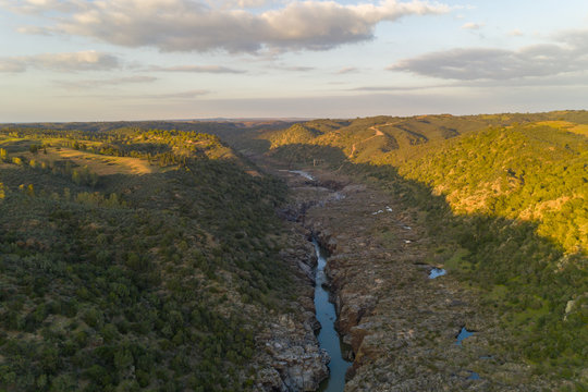 Pulo do Lobo waterfall drone aerial view with river guadiana and beautiful green valley landscape at sunset in Mertola Alentejo, Portugal