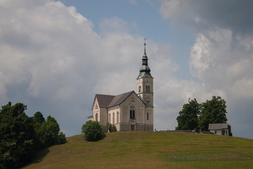 Fototapeta na wymiar Church of Saint Lenart in Črni Vrh near Polhov Gradec and Škofja Loka in Slovenia. Beautiful Roman Catholic Church.