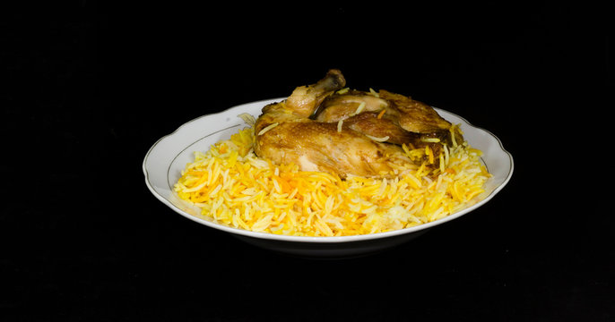 chicken Kabsa - mixed rice dishes that originates in Yemen. Middle eastern food. isolated on black background- Image