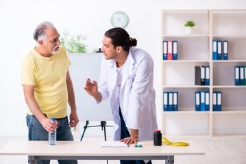 Fototapeta premium Doctor dietician giving advices to fat overweight patient