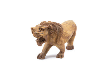 Naklejka premium Lion carved out of hardwood isolated on a white background.
