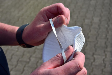 Hands holding a respiratory mask.