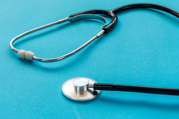 Medical stethoscope on a blue background close up