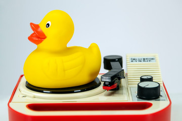Rubber duck on vintage record player.