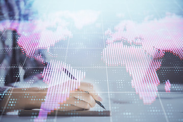 International business hologram over hands taking notes background. Concept of success. Multi exposure