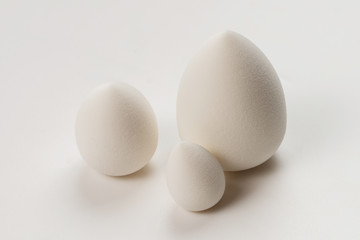 Small, medium and large  white beauty blender isolated.