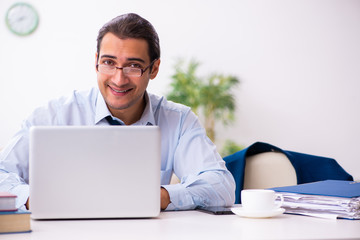 Young male employee working from house