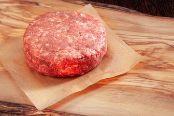 Fresh raw Ground beef meat Burger (beef burger) steak cutlet on wooden board.  Selective focus