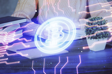 Cryptocurrency hologram over hands taking notes background. Concept of blockchain. Multi exposure