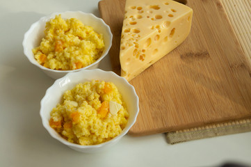 millet porridge with pumpkin and cheese on the table