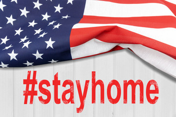 Fototapeta na wymiar USA flag on wooden wall with text #stayhome