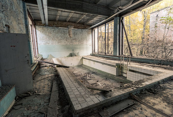 Fototapeta na wymiar Abandoned empty swimming pool in school in Pripyat near Chernobyl in Ukraine