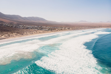 Aerial view of Famara beach, scenic landscape with ocean and mountains in Lanzarote, Canary islands