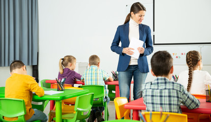 Teacher controlling learning process in primary school