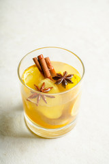 Healthy hot beverage with lemon, ginger and spices for protection in flu season. Selective focus. Shallow depth of field.