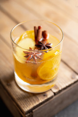 Healthy hot beverage with lemon, ginger and spices for protection in flu season. Selective focus. Shallow depth of field.