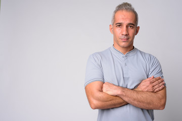 Fototapeta premium Portrait of handsome Persian man with arms crossed