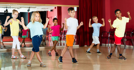 Boys and girls having dancing class in studio