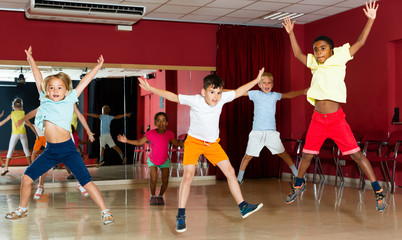 Cheerful children jumping while studying dance